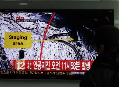 A South Korean passenger watches TV news reporting an earthquake in North Korea as a result of the nuclear test
