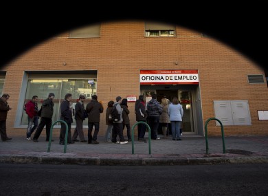 People queue to enter on an unemployment office in Madrid, Spain